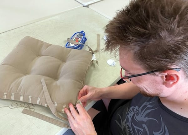 A person sewing a cushion